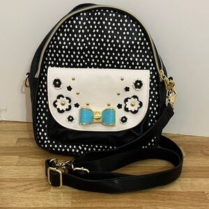 Betsey Johnson whitePolka Dot Backpack/crossbody bag. Front Pocket magnet close.